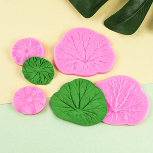 Macro shot of detailed lotus leaf silicone molds showing fine vein textures in pink and green