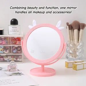 Cute pink tabletop makeup mirror with animal ears and adjustable stand on vanity desk