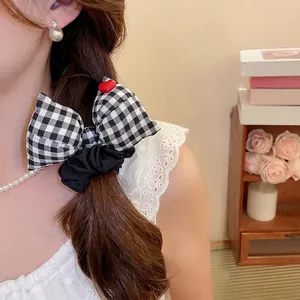 Elegant checkered bow hair scrunchie with red heart accent in a French vintage style