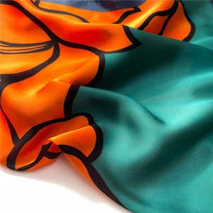 Macro shot of abstract floral print silk scarf with luxury satin sheen and texture