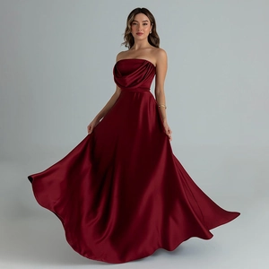 Detailed view of elegant burgundy satin strapless gown with pleated bodice and A-line hem