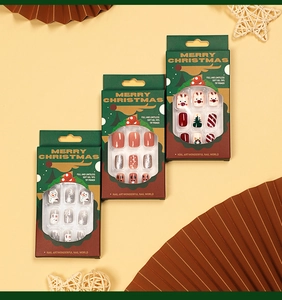 Detailed view of Christmas press-on nails featuring elk, snowman and tree designs