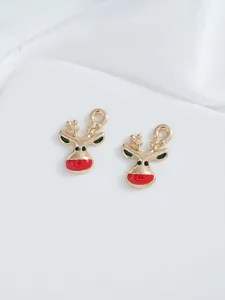 Detail of two gold enamel reindeer charms for DIY Christmas jewelry and necklace making