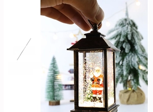 Close-up of a bronze Christmas lantern with Santa Claus and sparkling glitter inside