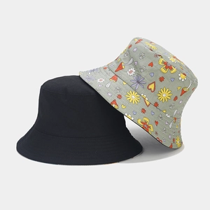 Flat lay of cotton bucket hats with floral mushroom print and solid black canvas design