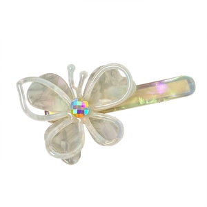 Iridescent butterfly hair clip with hollow wings and central rhinestone on white background