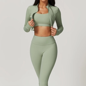 Detailed sage green three-piece yoga set with zip jacket, sports bra, and high-waist leggings