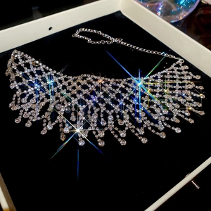 Close-up of sparkling silver rhinestone tassel necklace on black velvet display