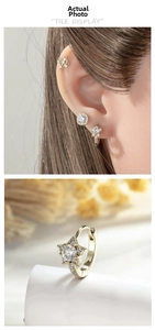 Macro detail of gold star stud earrings set with sparkling zircon crystals on model