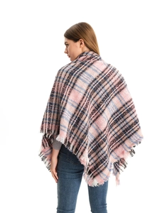 Detail of pink plaid shawl with tassel edges showing draped back view on white background