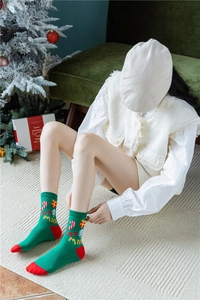 Détails des chaussettes de Noël à mi-mollet avec motifs festifs et broderies de Noël
