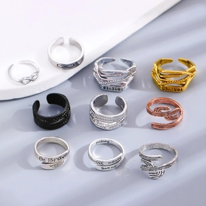 Macro view of assorted minimalist rings with motivational engravings on stone base