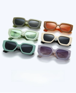 Colorful retro rectangular sunglasses in olive green, mint, orange, and purple hues