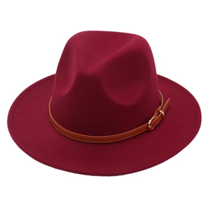 Detail of burgundy wool fedora hat featuring a brown faux leather belt with a gold buckle