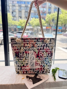 Detail of canvas tote bag with foam print letters and thick hemp rope handle