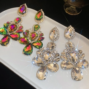 Detailed macro view of large cluster teardrop earrings with colorful and clear crystals