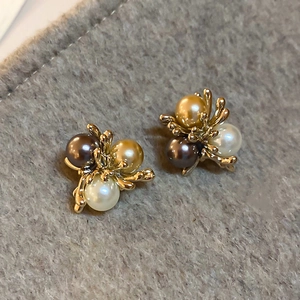 Detailed close-up of French vintage floral studs with white, gold, and coffee pearls