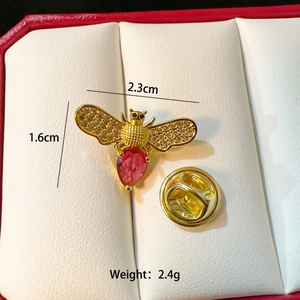 Exquisite gold bee brooch with sparkling wings and a red crystal drop body, 2.3cm wide