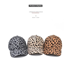 Detailed display of three leopard print corduroy baseball caps in grey, beige and brown
