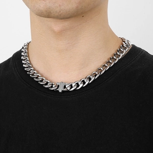 Close-up of 13mm silver stainless steel NK chain necklace worn by male model