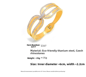 Détail d'un bracelet manchette en acier plaqué or 18k avec un motif papillon en cristal