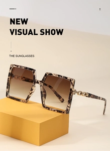 Detail of leopard print sunglasses with golden chain hinge and gradient lenses