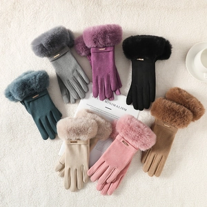 Detailed flat lay of colorful winter thermal gloves with faux fur trim and gold accents