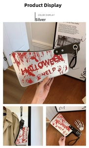 Detail of silver kitchen knife bag with red blood splatter and Halloween Help text