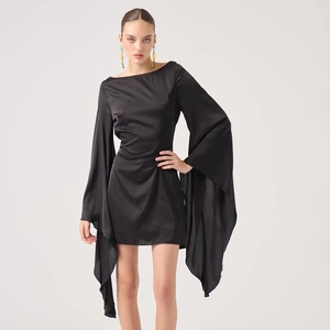 Detail of elegant black satin mini dress showing long flared sleeves and smooth fabric