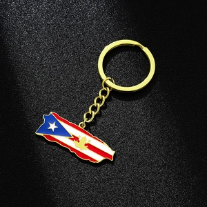 Detail of Puerto Rico map pendant keychain with colorful enamel flag and golden coqui charm
