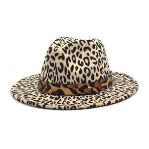 Detail of leopard print fedora hat featuring wide brim and golden metal rivet stud accent