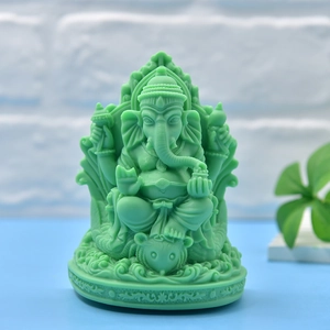 Green Ganesha elephant statue sculpture on a blue surface for home decor and gifts