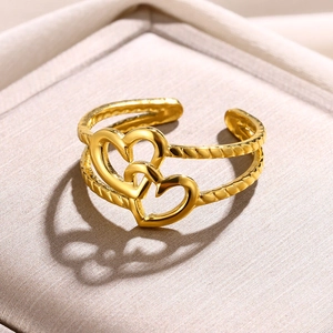 Detail of interlocking heart rings with gold rope texture on a satin background
