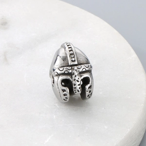 Detailed macro view of Spartan helmet bead accessory in silver stainless steel finish