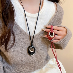 Detail of teardrop pendant necklace in glossy black and wine red with cord