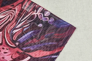 Detail of floral mesh fabric with double stitching on a slim fit turtleneck dress