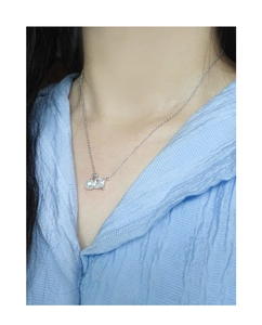 Close-up of S925 silver necklace featuring a round pearl and square zircon pendant