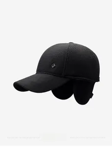 Close-up of black winter baseball cap featuring ear flaps and metallic diamond logo