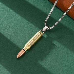 Close-up of gold bullet pendant with Cross Fire engraving on silver hip hop chain