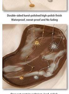 Polished gold and silver sun face necklaces on marble tray showing waterproof quality