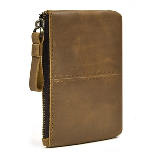 Detail of brown genuine crazy horse leather texture with wrist strap and metal zipper