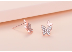 Macro shot of rose gold butterfly earrings with sparkling cubic zirconia pavé details