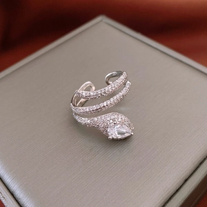 Macro shot of silver snake ring with pavé crystals and pear-cut zircon stone detail