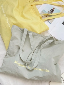 Minimalist canvas tote bag with French croissant text and wrinkled texture fabric