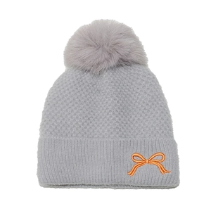 Detailed knit texture of light gray winter hat featuring fluffy pom-pom and orange bow