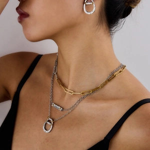 Detail of layered 18K gold and silver two-tone soda can pendant necklace with earrings