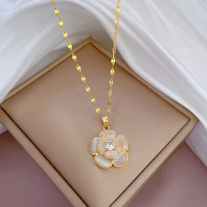 Titanium steel gold necklace with cat-eye flower pendant on soft silk fabric