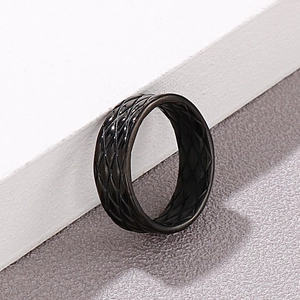 Macro shot of matte black stainless steel ring featuring vintage diamond lattice texture