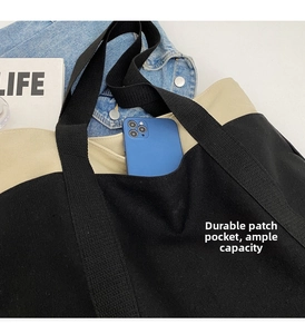 Macro shot of large canvas tote bag front pocket showing phone storage capacity