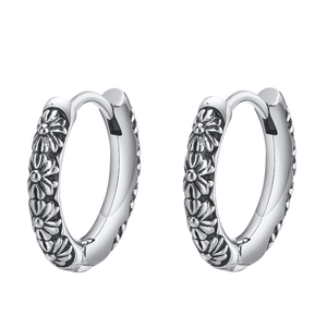Vintage silver hoop earrings featuring continuous embossed daisy floral patterns